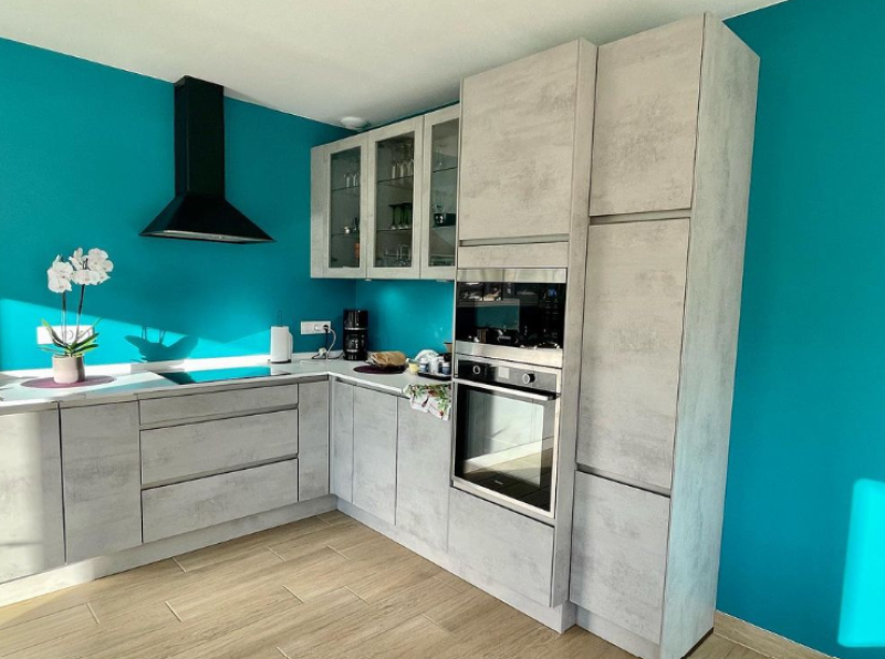 Cuisine moderne effet béton clair et plan de travail blanc à Mérignac